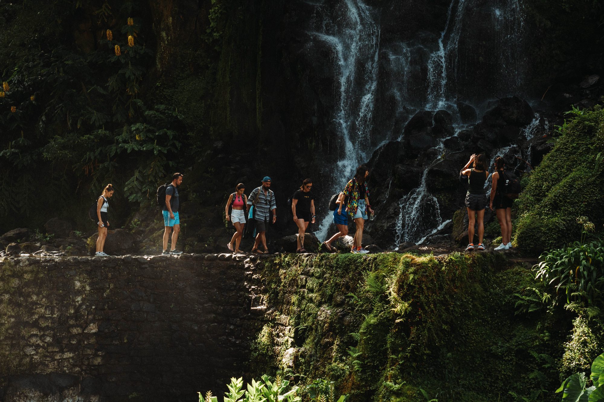 Walking past a waterfall on São Miguel